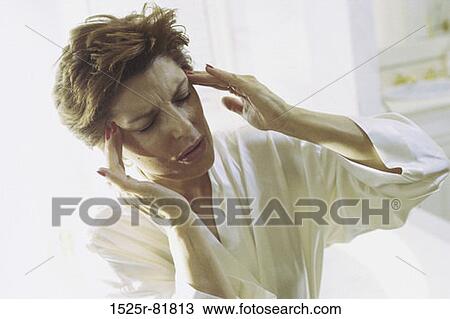Woman holding the side of her head in pain View Large Photo Image Stock Image - Woman holding the side of her head in pain. Fotosearch