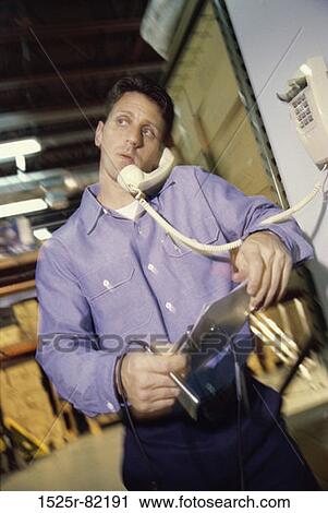Stock Image - Worker talking on a telephone. Fotosearch