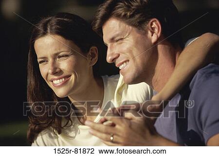 Young couple holding each other View Large Photo Image Stock Image - Young couple holding each other. Fotosearch