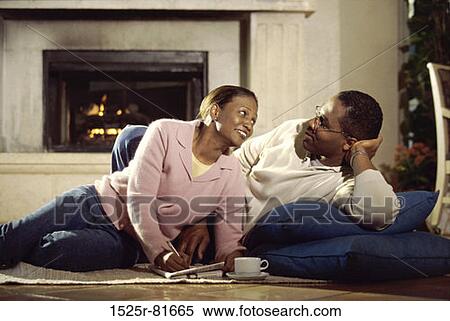Young couple lying on the floor together View Large Photo Image Stock Photography - Young couple lying on the floor together. Fotosearch