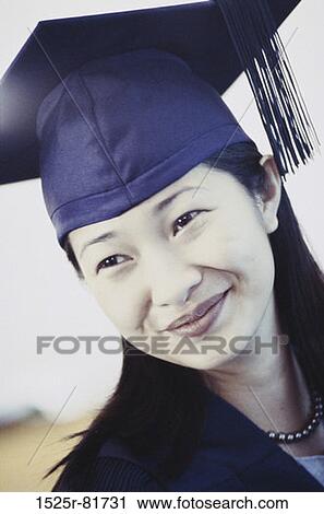 Stock Image - Young female graduate smiling. Fotosearch