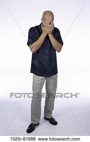 Young man covering his face with his hands View Large Photo Image Stock Photo - Young man covering his face with his hands. Fotosearch
