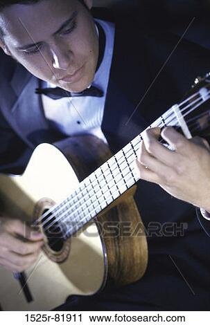 Young man playing the guitar View Large Photo Image Stock Image - Young man playing the guitar. Fotosearch