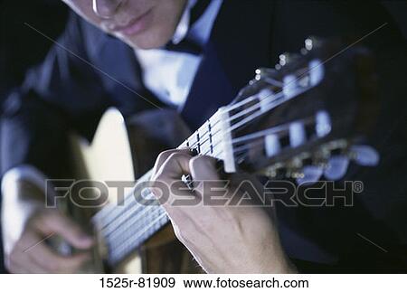 Young man playing the guitar View Large Photo Image Stock Photo - Young man playing the guitar. Fotosearch
