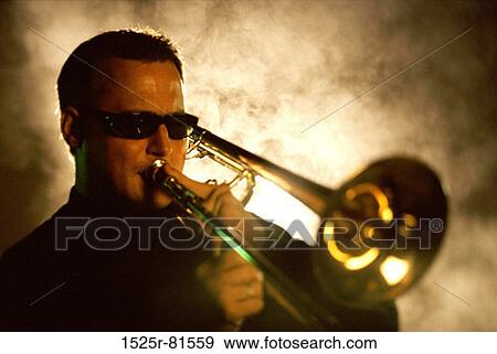 Young man playing the trombone View Large Photo Image Stock Photo - Young man playing the trombone. Fotosearch