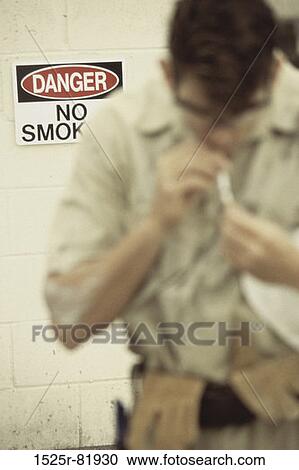 Young man smoking a cigarette View Large Photo Image Stock Image - Young man smoking a cigarette. Fotosearch