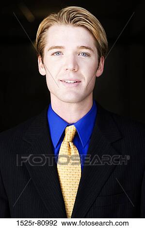 Blond hair businessman smiles with a gold tie and black suit View Large Photo Image Stock Image - Blond hair businessman smiles with a gold tie and black suit. Fotosearch