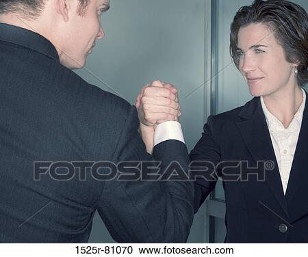 Business man and business woman grasp hands together View Large Photo Image Stock Image - Business man and business woman grasp hands together. Fotosearch