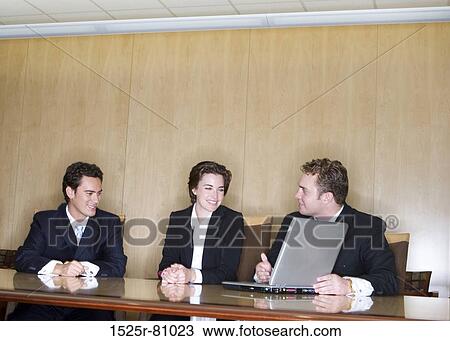 Business Man teaches with his laptop to two other business people View Large Photo Image Stock Image - Business Man teaches with his laptop to two other business people. Fotosearch