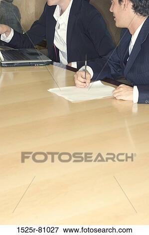 Business meeting in the board room on the conference table with copy space in the fore ground View Large Photo Image Stock Photo - Business meeting in the board room on the conference table with copy space in the fore ground. Fotosearch