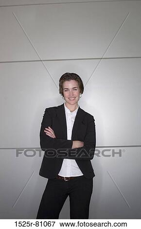 Business woman in black and white clothes stands in dynamic pose against a metallic background View Large Photo Image Stock Photo - Business woman in black and white clothes stands in dynamic pose against a metallic background. Fotosearch