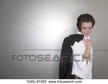 Business woman in white shirt holds jacket over her shoulder View Large Photo Image Stock Image - Business woman in white shirt holds jacket over her shoulder. Fotosearch