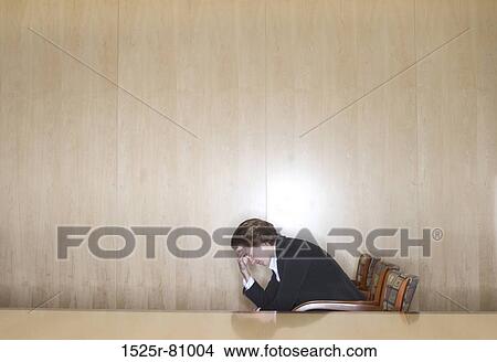 Business woman sitting in the chair with her hands in on her head in distress View Large Photo Image Picture - Business woman sitting in the chair with her hands in on her head in distress. Fotosearch