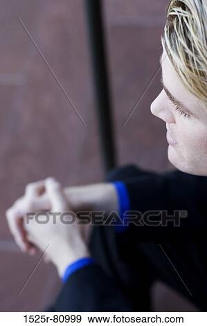Stock Photo - Businessman sits and thinks about his workday on the steps. Fotosearch