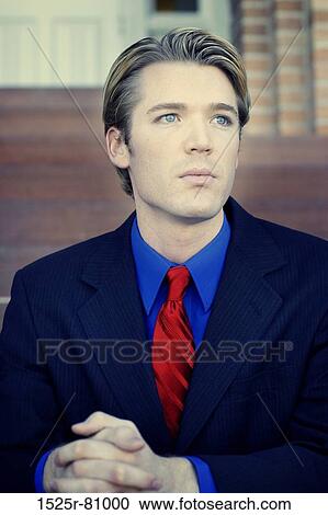 Businessman sits with and thinks on the steps with his red tie and suit View Large Photo Image Stock Image - Businessman sits with and thinks on the steps with his red tie and suit. Fotosearch