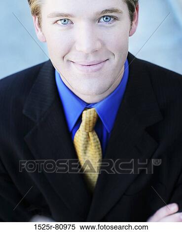 Businessman stands and smiles as he looks up View Large Photo Image Stock Photography - Businessman stands and smiles as he looks up. Fotosearch