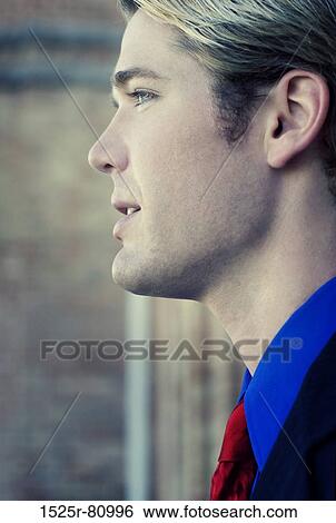 Businessman wears a red tie and looks ahead View Large Photo Image Stock Photograph - Businessman wears a red tie and looks ahead. Fotosearch