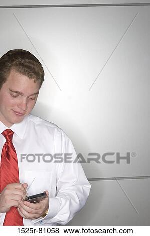 Close-up of a businessman operating a personal data assistant View Large Photo Image Stock Photo - Close-up of a businessman operating a personal data assistant. Fotosearch