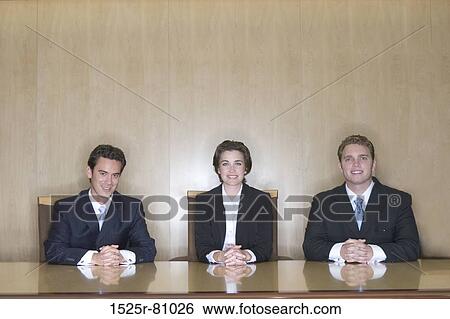 Three Business people sitting in the board room giving an interview View Large Photo Image Stock Photograph - Three Business people sitting in the board room giving an interview. Fotosearch