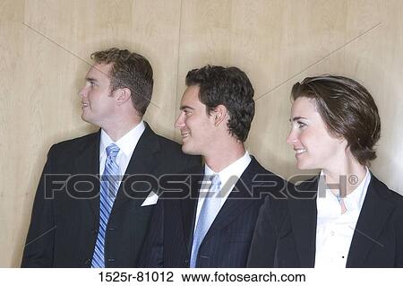 Three business people stand together and face towards the future View Large Photo Image Stock Image - Three business people stand together and face towards the future. Fotosearch