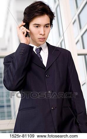 Close-up of a businessman talking on a mobile phone View Large Photo Image Stock Photo - Close-up of a businessman talking on a mobile phone. Fotosearch
