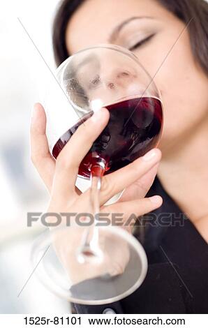 Low angle view of a businesswoman drinking red wine View Large Photo Image Stock Image - Low angle view of a businesswoman drinking red wine. Fotosearch