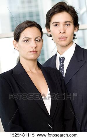 Portrait of a businessman and a businesswoman standing together in front of a window View Large Photo Image Stock Photography - Portrait of a businessman and a businesswoman standing together in front of a window. Fotosearch