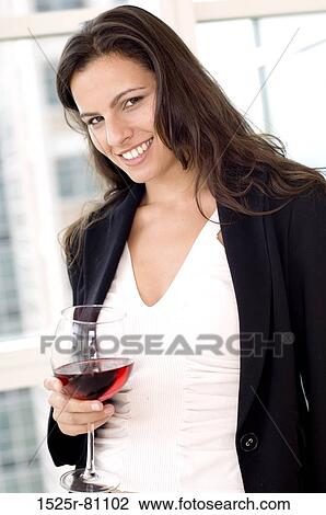 Portrait of a businesswoman holding a glass of red wine and smiling View Large Photo Image Stock Image - Portrait of a businesswoman holding a glass of red wine and smiling. Fotosearch