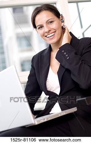 Portrait of a businesswoman sitting with a laptop on her lap and smiling View Large Photo Image Stock Photograph - Portrait of a businesswoman sitting with a laptop on her lap and smiling. Fotosearch