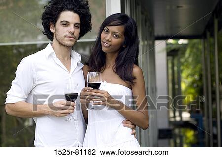 Portrait of a young couple holding wineglasses View Large Photo Image Stock Image - Portrait of a young couple holding wineglasses. Fotosearch
