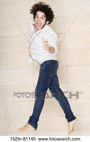 Portrait of a young man wearing headphones and dancing View Large Photo Image Stock Image - Portrait of a young man wearing headphones and dancing. Fotosearch