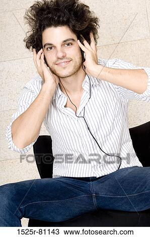 Portrait of a young man wearing headphones View Large Photo Image Stock Image - Portrait of a young man wearing headphones. Fotosearch