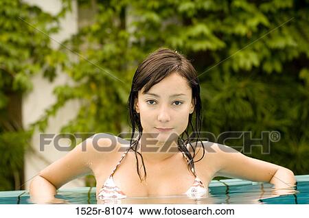 Portrait of a young woman in a swimming pool View Large Photo Image Picture - Portrait of a young woman in a swimming pool. Fotosearch