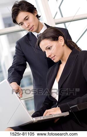 Side profile of a businesswoman and a businessman looking at a laptop View Large Photo Image Stock Photography - Side profile of a businesswoman and a businessman looking at a laptop. Fotosearch
