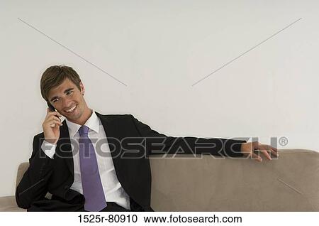 Businessman talking on a mobile phone View Large Photo Image Stock Image - Businessman talking on a mobile phone. Fotosearch