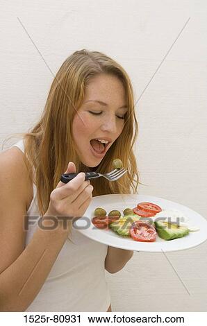 Close-up of a young woman eating an olive View Large Photo Image Stock Image - Close-up of a young woman eating an olive. Fotosearch