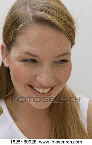 Close-up of a young woman smiling View Large Photo Image Stock Photo - Close-up of a young woman smiling. Fotosearch