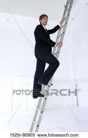 Portrait of a businessman climbing a ladder View Large Photo Image Stock Image - Portrait of a businessman climbing a ladder. Fotosearch