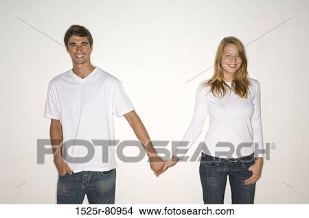 Portrait of a young couple holding each other's hands and smiling View Large Photo Image Picture - Portrait of a young couple holding each other's hands and smiling. Fotosearch