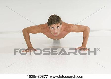Portrait of a young man doing push-ups View Large Photo Image Stock Photo - Portrait of a young man doing push-ups. Fotosearch