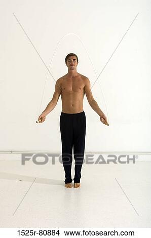 Portrait of a young man jumping with a jump rope View Large Photo Image Picture - Portrait of a young man jumping with a jump rope. Fotosearch
