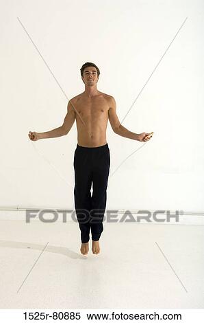 Portrait of a young man jumping with a jump rope View Large Photo Image Stock Photography - Portrait of a young man jumping with a jump rope. Fotosearch