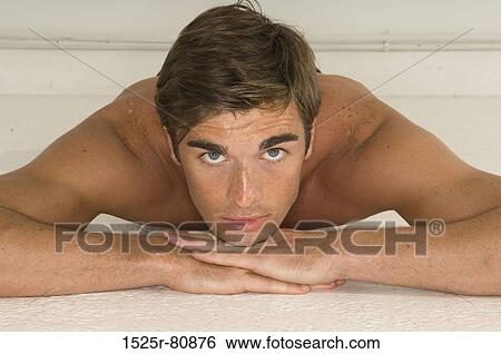 Portrait of a young man lying down View Large Photo Image Stock Photograph - Portrait of a young man lying down. Fotosearch