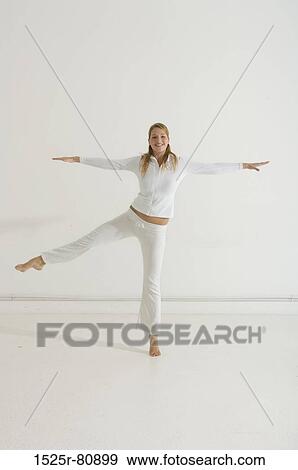 Stock Photo - Portrait of a young woman exercising. Fotosearch