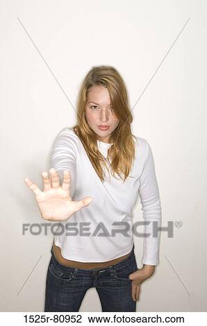 Portrait of a young woman making a stop gesture View Large Photo Image Stock Image - Portrait of a young woman making a stop gesture. Fotosearch