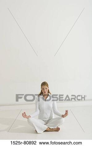 Portrait of a young woman practicing yoga View Large Photo Image Stock Image - Portrait of a young woman practicing yoga. Fotosearch