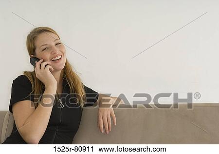 Portrait of a young woman talking on a mobile phone View Large Photo Image Stock Image - Portrait of a young woman talking on a mobile phone. Fotosearch