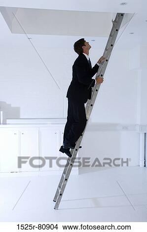 Side profile of a businessman climbing a ladder View Large Photo Image Picture - Side profile of a businessman climbing a ladder. Fotosearch
