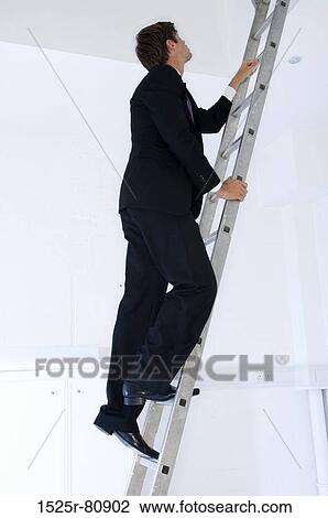 Side profile of a businessman climbing a ladder View Large Photo Image Stock Image - Side profile of a businessman climbing a ladder. Fotosearch