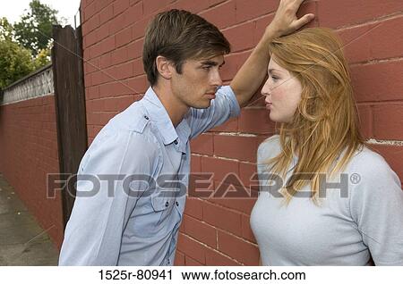 Side profile of a young couple looking at each other View Large Photo Image Stock Image - Side profile of a young couple looking at each other. Fotosearch